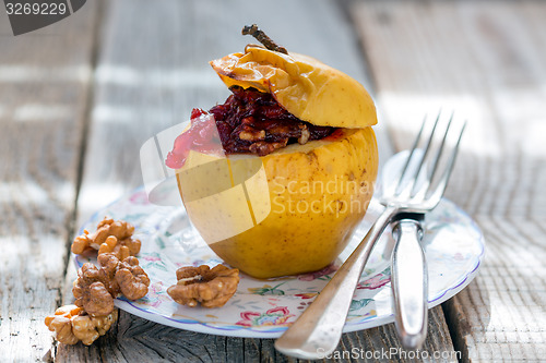 Image of Baked apple with nuts and cowberry.