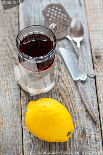 Image of Black tea in glass and lemon.
