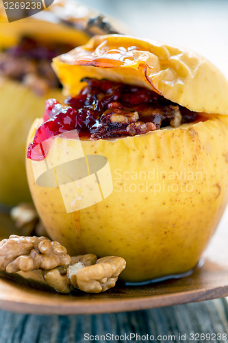 Image of Baked apple stuffed with berries and nuts.