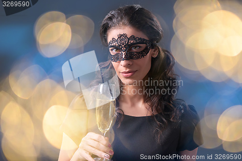 Image of Party woman holding glass with champagne