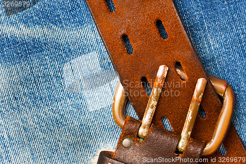 Image of unfastened old leather belt with vintage buckles
