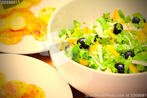 Image of Assorted green leaf lettuce with squid and black olives