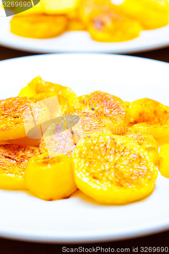 Image of slices of baked potatoes on a white plate