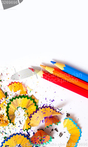 Image of three colored pencils and shavings