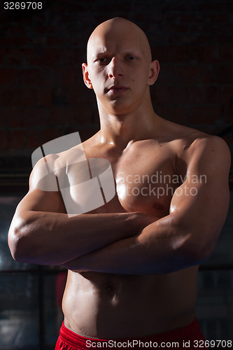Image of boxer with arms crossed