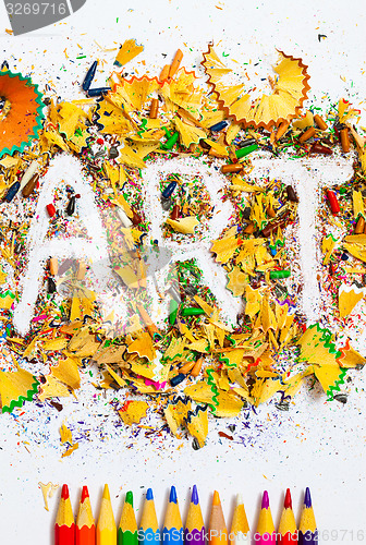 Image of ART word on the background of colored shavings