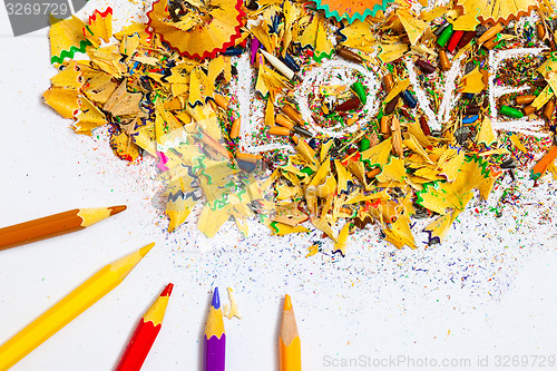 Image of The word LOVE on the background of pencil shavings