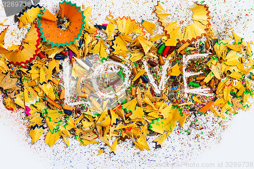 Image of The word Love on colored pencil shavings