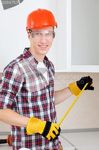 Image of repairman with a tape measure