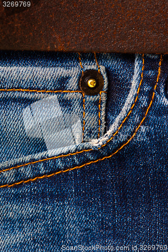 Image of jeans with a brown leather belt