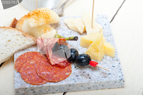 Image of mix cold cut on a stone with fresh pears