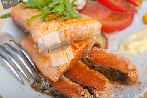 Image of grilled samon filet with vegetables salad