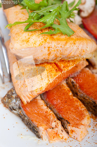 Image of grilled samon filet with vegetables salad