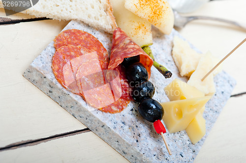 Image of mix cold cut on a stone with fresh pears