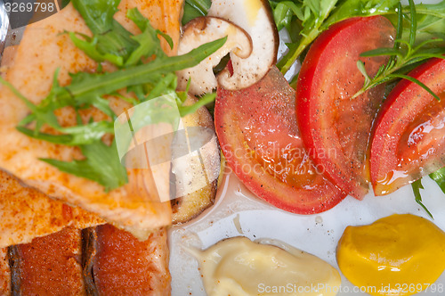 Image of grilled samon filet with vegetables salad