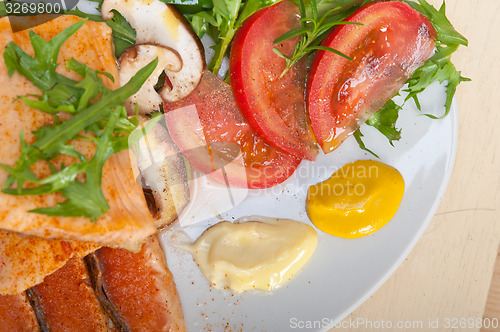 Image of grilled samon filet with vegetables salad