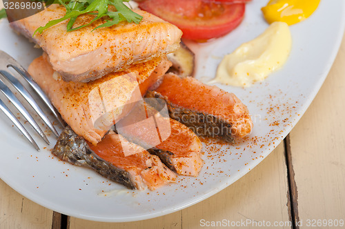 Image of grilled samon filet with vegetables salad