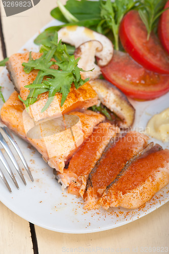 Image of grilled samon filet with vegetables salad