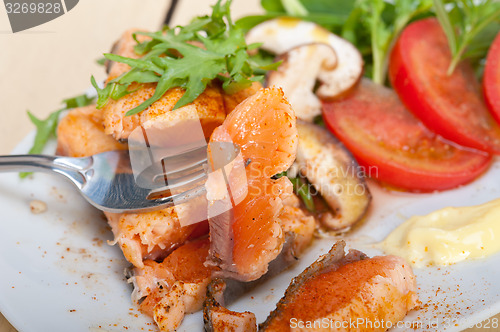 Image of grilled samon filet with vegetables salad