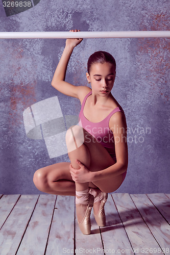Image of Ballerina stretching on the bar