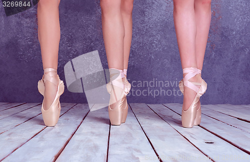 Image of The feet of a young ballerinas in pointe shoes 