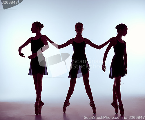 Image of Composition from silhouettes of three young ballet dancers