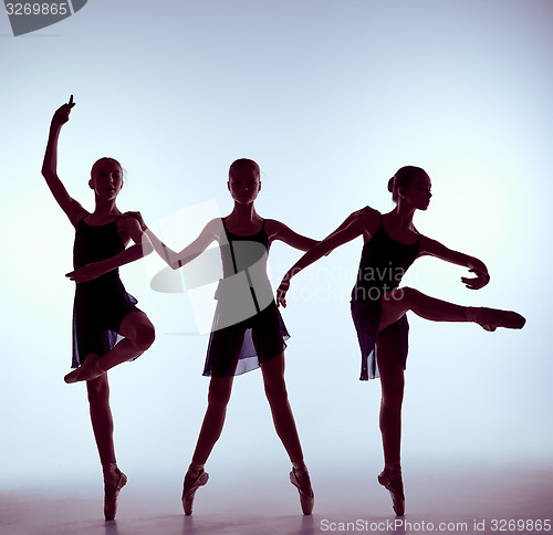 Image of Composition from silhouettes of three young ballet dancers