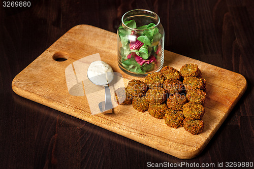 Image of fresh vegetarian falafel  with sauce, selective focus