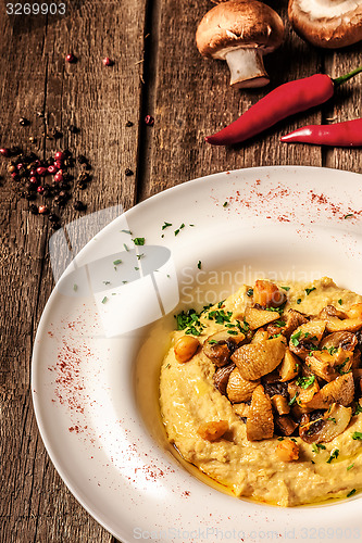 Image of corn porridge with pumpkin on white wooden background