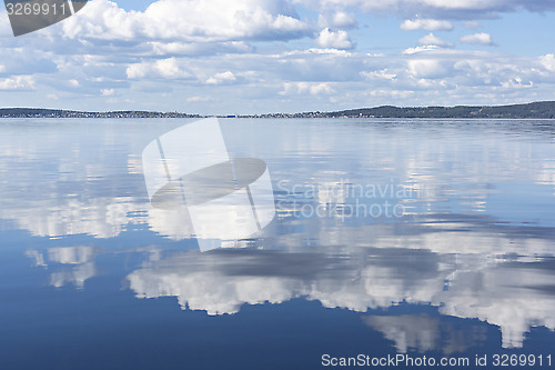 Image of Reflection of clouds on lake water