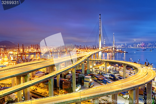 Image of Container Cargo freight ship with working crane bridge in shipya