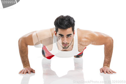 Image of Athletic man doing push-up