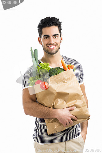 Image of Man carrying a bag full of vegetables