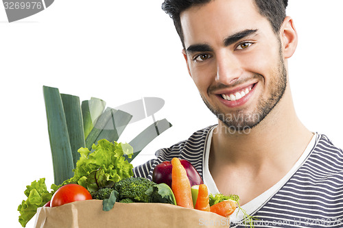 Image of Man carrying a bag full of vegetables