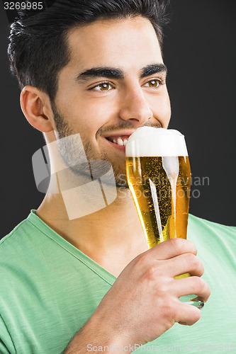 Image of Young man drinking beer