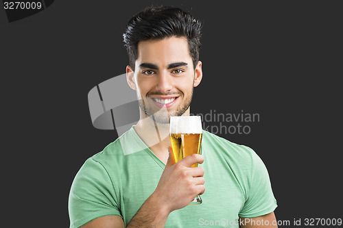 Image of Young man drinking beer