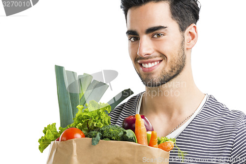 Image of Man carrying a bag full of vegetables