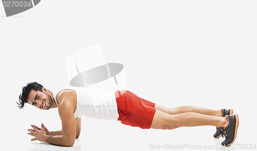 Image of Athletic man doing push-up