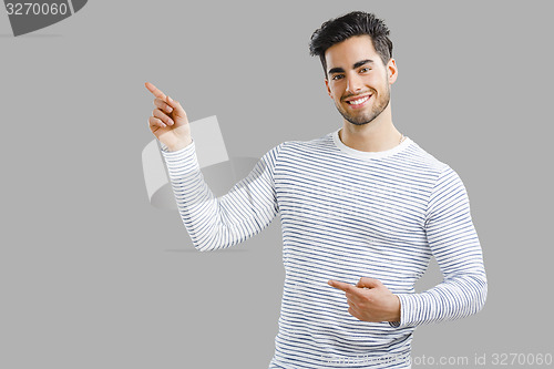 Image of Handsome young man pointing