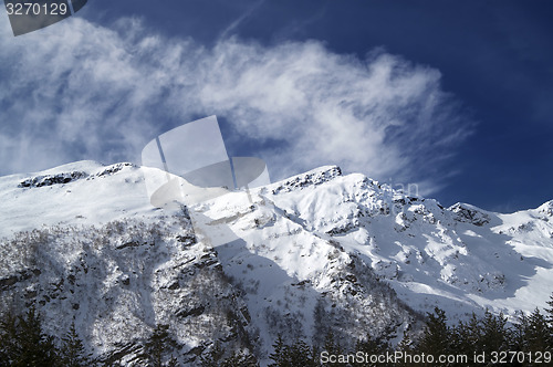 Image of View on off-piste ski slope at sun windy day