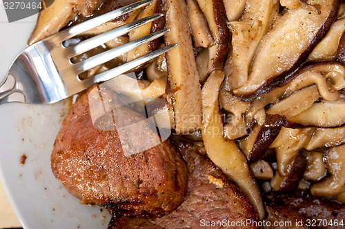 Image of venison deer game filet and wild mushrooms