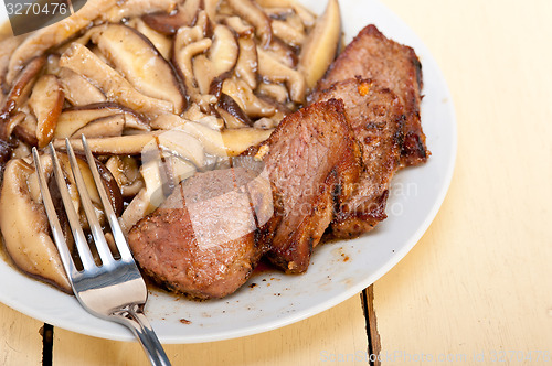 Image of venison deer game filet and wild mushrooms