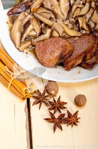 Image of venison deer game filet and wild mushrooms