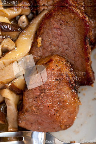 Image of venison deer game filet and wild mushrooms