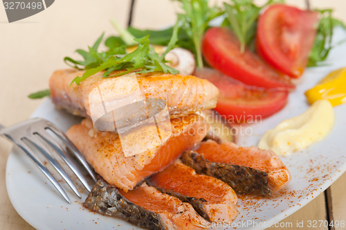 Image of grilled samon filet with vegetables salad