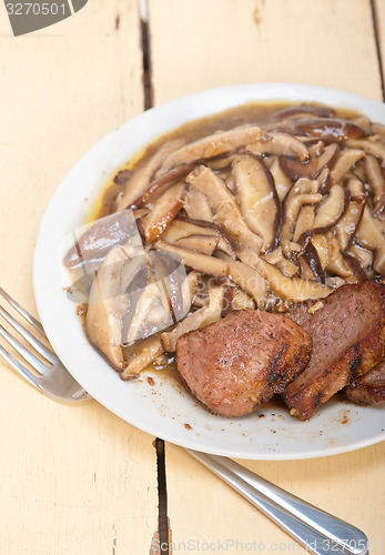 Image of venison deer game filet and wild mushrooms