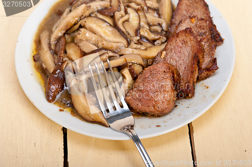 Image of venison deer game filet and wild mushrooms