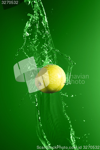 Image of Green apple with water splash, on green