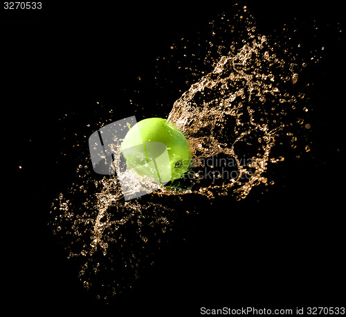 Image of Green apple with water splash, on black