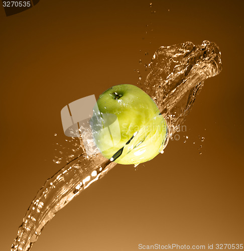 Image of Green apple with water splash, on beige